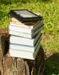 Stack of colorful books with e-book reader