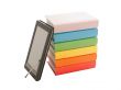 Stack of colorful books and e-book reader