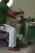 Craftsman using grinder in workshop
