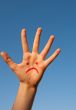 Human`s palm with unhappy smiley drawn on it