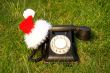 Old fashioned black telephone with Santa`s hat