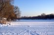 The frozen river under snow