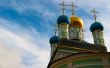 Orthodox domes of russian church and cloud on sky