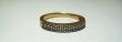 Golden ring with a white stones isolated