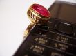 Mobile phone and golden ring with red stone