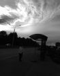 Silhouette of pavilion of a bus stop and cloud