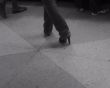 Shoes on a high heel against a stone floor.