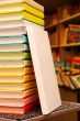 Book staying at stack of colorful books