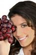 Woman with bunch of ripe grapes