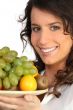 a woman holding a fruits plate