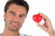 Portrait of a man holding a heart