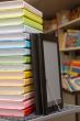 Stack of colorful books with e-book reader