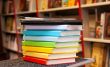 Stack of colorful books with e-book reader