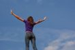 Young woman staying with raised hands