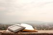 E-book reader laying on the book outdoors