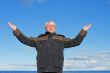 Middle-aged man on blue sky of the background.