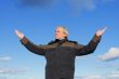 Middle-aged man on blue sky of the background.