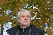 Portrait of middle-aged man in autumn day.
