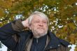 Portrait of middle-aged man in autumn day.
