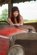 Young woman with old car.