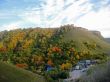 Golden autumn, blue sky and caucasus mountains