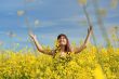 Happy girl in flower meadow.