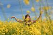 Happy girl in flower meadow.