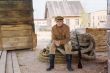 Retro style picture with soldier sitting on rope