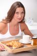 brunet having breakfast in bed