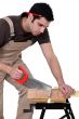 Man cutting a piece of wood