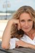 Blond woman sat on bench