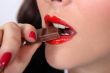 Closeup of a woman eating chocolate