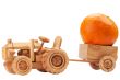 Toy tractor with orange pumpkin.