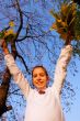 Girl playing with leaves at fall time
