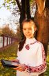 Teen girl with e-book reader in a park