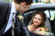 Bride in car and groom
