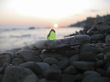 Green glass laying on the sea shore