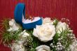 wedding rings in blue box and rose