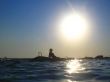 Woman and splashing water of the sea and big sun