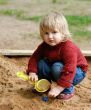 child plays with sand