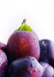 Plums. Fresh ripe washed plums over white background