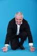Businessman attempting to lift