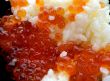 Rice with red caviar in black chalice