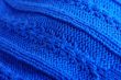 Knit woolen texture. Fabric blue background 