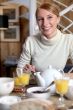 Woman eating breakfast at table