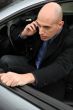 Man on phone getting out of his car