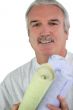 Decorator holding rolls of wallpaper
