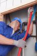 Skilled technician repairing canalizations