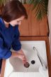 Female plumber installing a sink