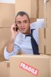 Cellphone user surrounded by boxes